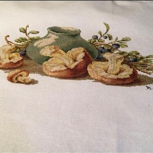Hand embroidered table scene in neutral colors.